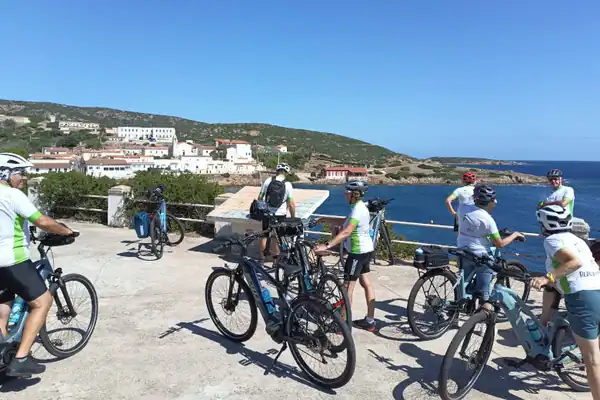 A small group of cyclists with their guide above the sea in Sardinia